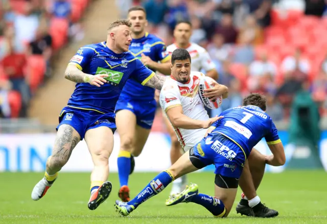 Warrington Wolves' Josh Charnley (left) challenges Catalan"s Fouad Yaha