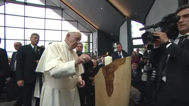 Pope lights a candle