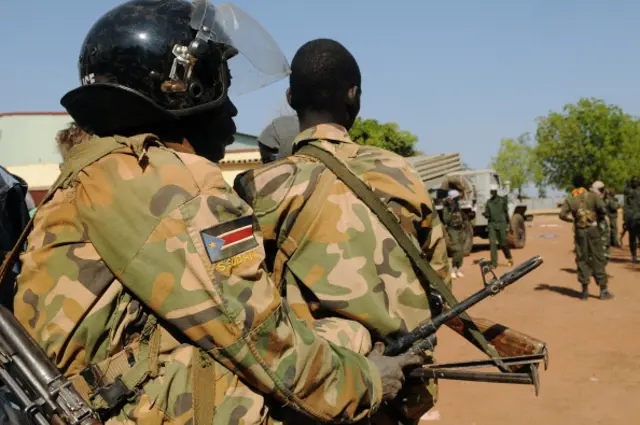 Members of South Sudan's former rebel army the Sudan People's Liberation Army (SPLA) walk in the empty north oil city of Bentiu after capturing it from rebels on January 12, 2014