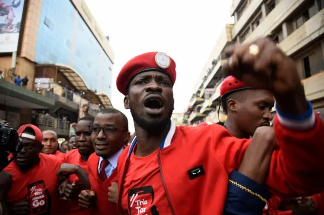 Robert Kyagulanyi (C) is joined by other activists in Kampala on July 11, 2018 in Kampala during a demonstration to protest a controversial tax on the use of social media.