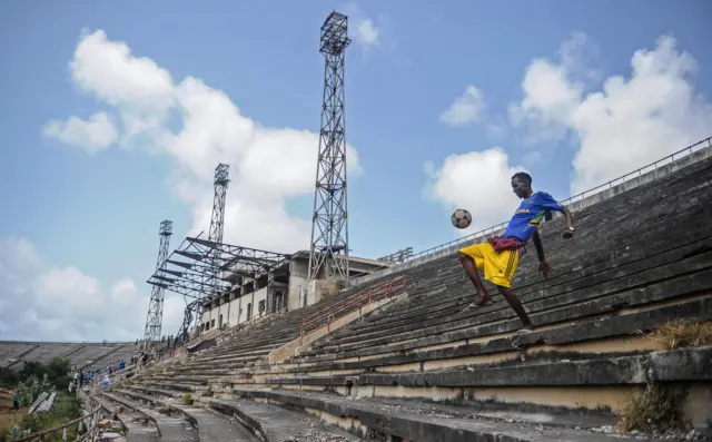 A man kicking a ball at Mogadishu stadium