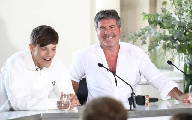 Louis Tomlinson and Simon Cowell