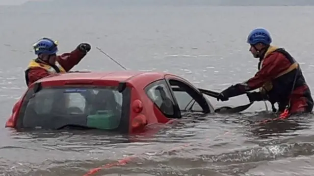 The car being pulled out of the water