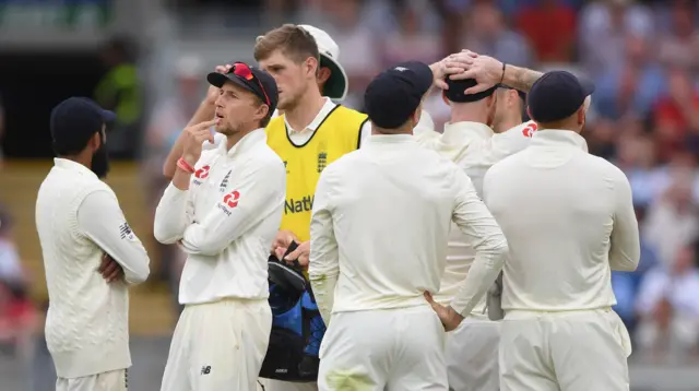 Joe Root looks at the big screen after a review for the wicket of Virat Kohli is turned down