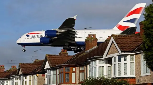 Plane over houses