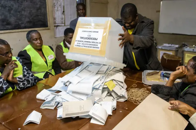 Electoral officers count ballot papers on the eve of the vote