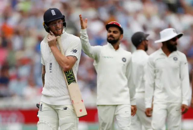 England"s Ben Stokes walks off the pitch after losing his wicket as India"s Virat Kohli gestures