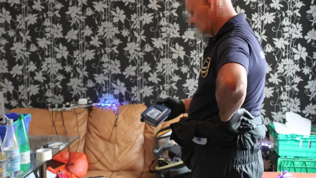 Police officer inspecting at the 'meth lab'