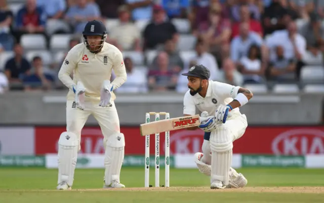 Jonny Bairstow looks on as India batsman Virat Kohli picks up some runs