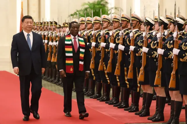 Zimbabwe's President Emmerson Mnangagwa (C) reviews a military honour guard with Chinese President Xi Jinping (L) during a welcoming ceremony at the Great Hall of the People in Beijing on April 3, 2018. Mnangagwa is on a visit to China to seek economic support from a major partner that previously backed his ousted predecessor Robert Mugabe.