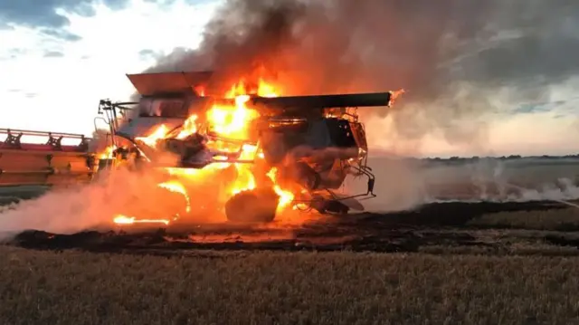 Combine harvester on fire