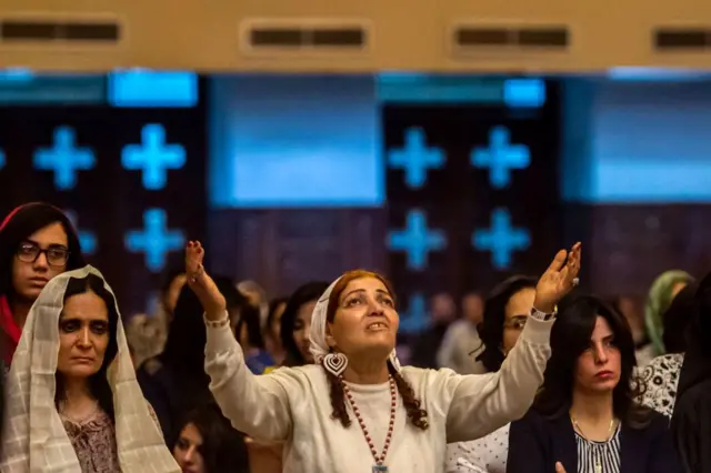 gyptian women attend an Easter mass led by Egypt's Coptic Christian, Pope Tawadros II at the Saint Mark's Coptic Cathedral, in Cairo's al-Abbassiya district late on April 15, 2017