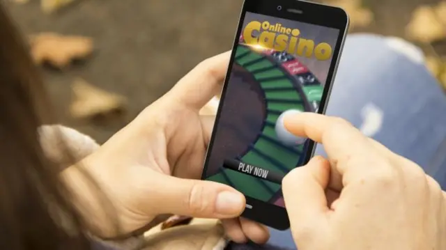 A person using a mobile app about gambling