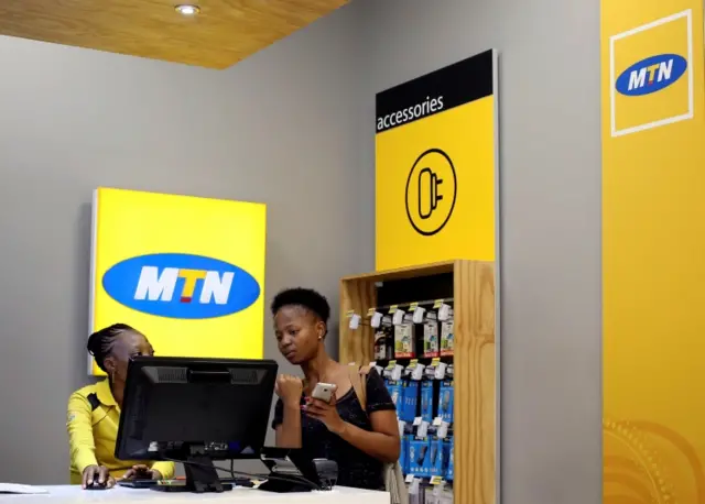 A worker attends to a customer at an MTN shop at a mall in Johannesburg, South Africa, March 2, 2017