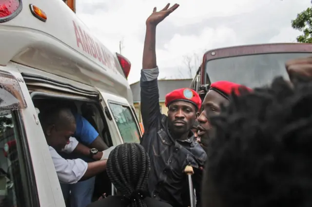 Robert Kyagulanyi (C), better known as Bobi Wine, reacts as he gets into an ambulance after being released on bail at The High Court in Gulu, northern Uganda, on August 27, 2018