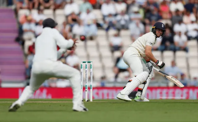 Jos Buttler watches as India"s Virat Kohli catches him