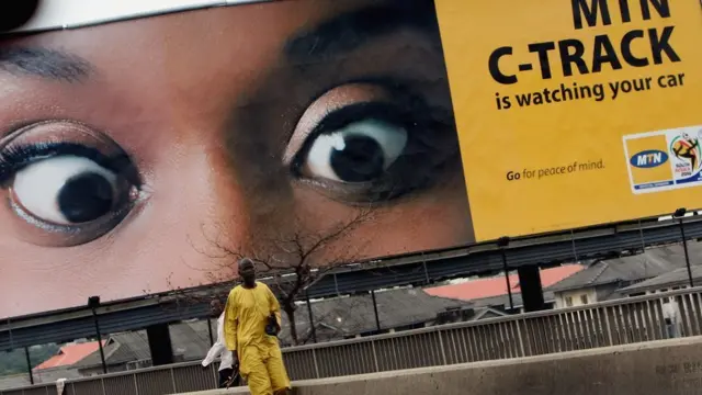 A man walks past a billboard for MTN, Africa's leading cullular telecommunication company on July 14, 2008 in Lagos, Nigeria.