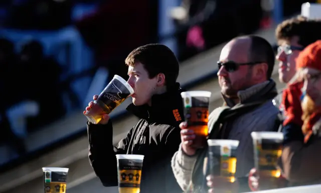 Fans drinking a beer