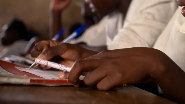 Pupil with exercise book