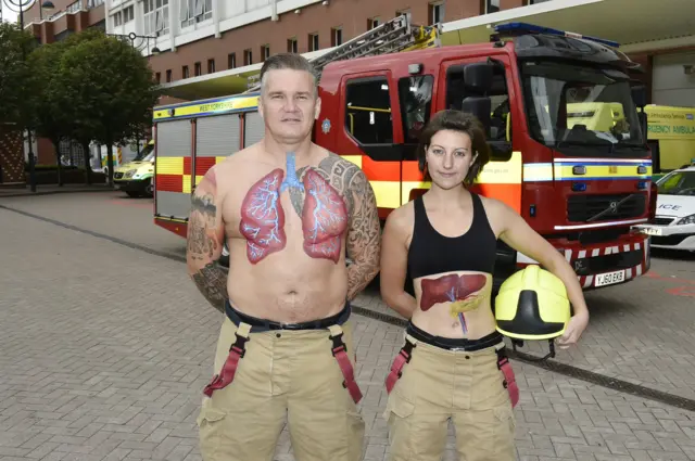 Firefighters with organs painted on their bodies