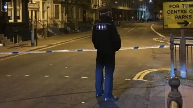 A police man standing at the scene