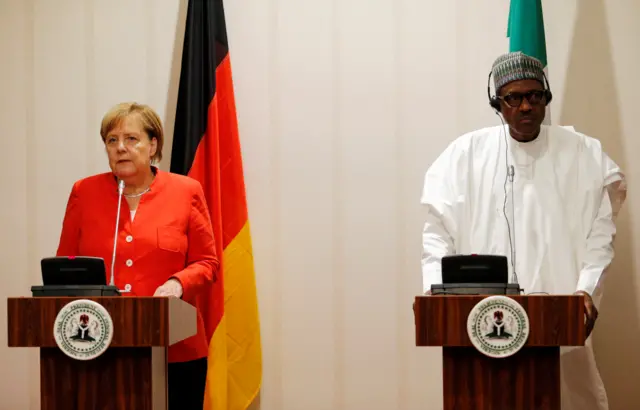 German Chancellor Angela Merkel and Nigeria"s President Muhammadu Buhari address a news conference at the presidential villa in Abuja, Nigeria