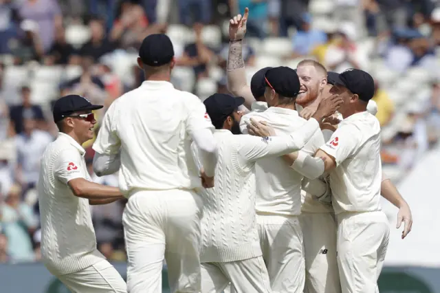 England"s Ben Stokes (2nd R) celebrates with teammates after taking the final wicket