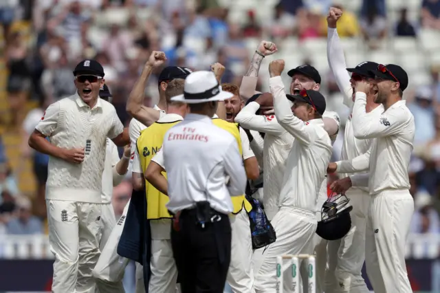 England"s players celebrate after the review confirms his dismissal of India"s Ishant Sharma