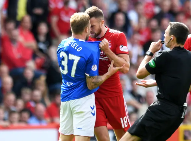 Rangers' Scott Arfield and Aberdeen's Mikey Devlin clash