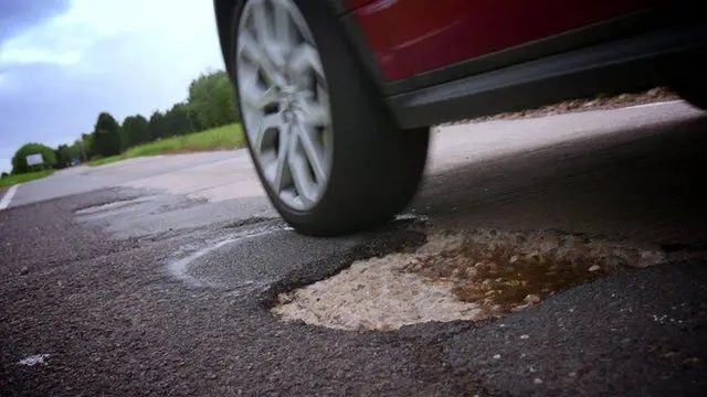 A car driving over a pothole