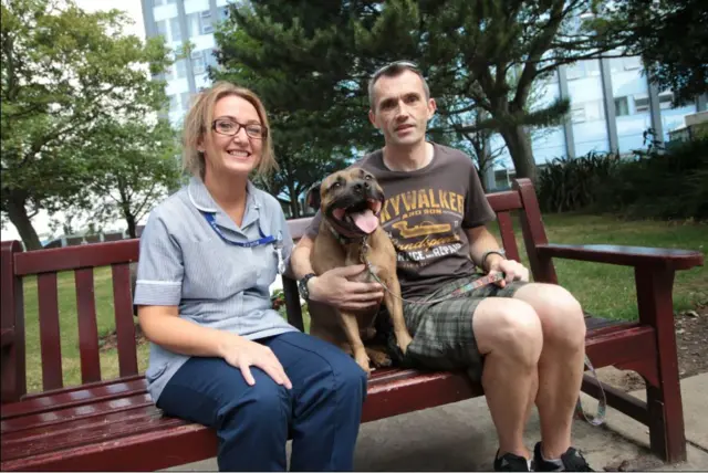 Nigel Sutcliffe with Jenny Wilson and Bruno the dog.