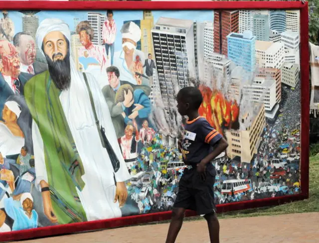 A boy walks past a painting in Nairobi