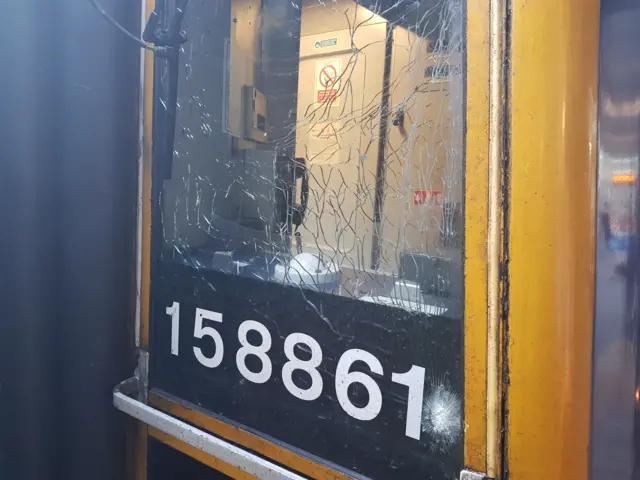 A smashed window on the front of a train