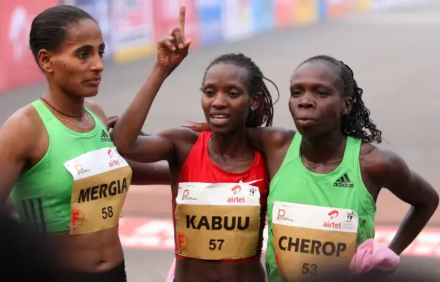 Lucy Kabuu pictured standing between two other athletes