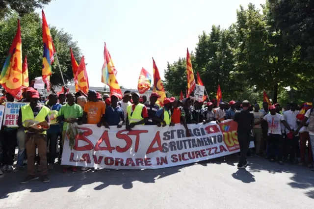 African migrant laborers stage a march to protest against their work conditions in Italy, following the death of 16 of their colleagues in two separate road accidents, in Foggia, Italy