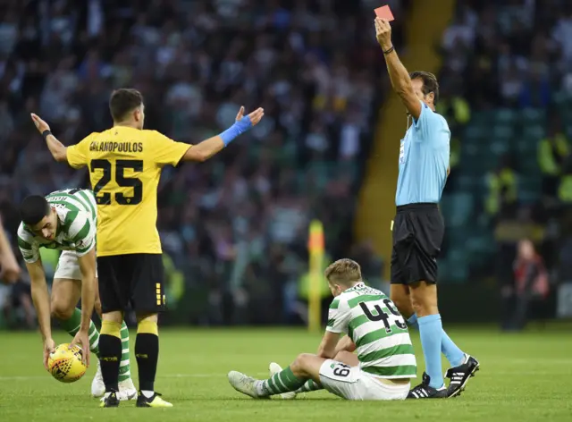 AEK's Konstantinos Galanopoulos is shown a second yellow and then a red card