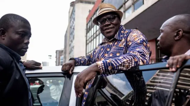 Tendai Biti pictured entering a car