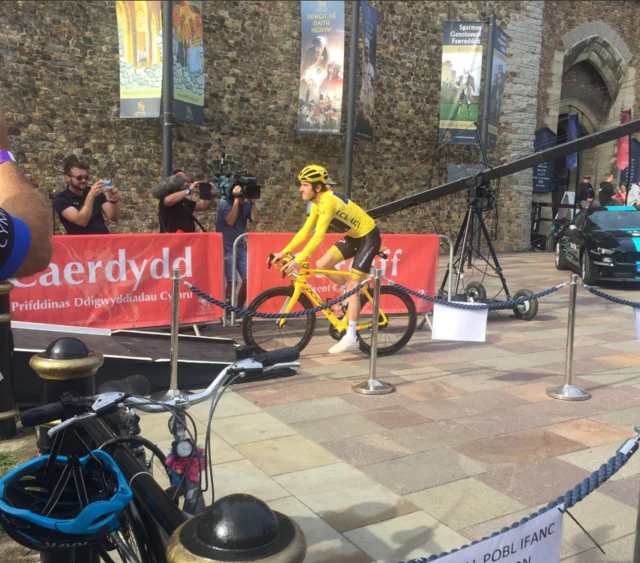 Geraint Thomas cycling onto stage outside Cardiff Castle