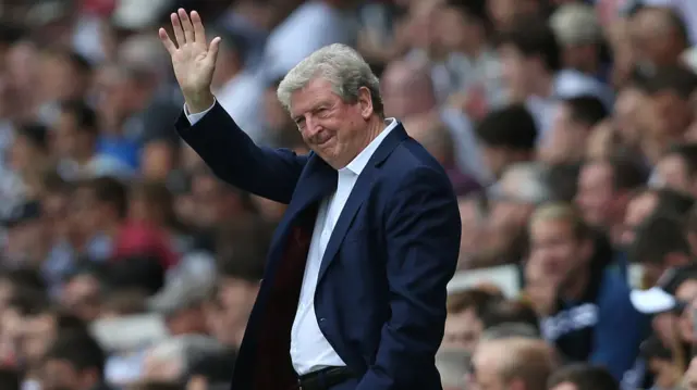 Roy Hodgson stands on the touchline