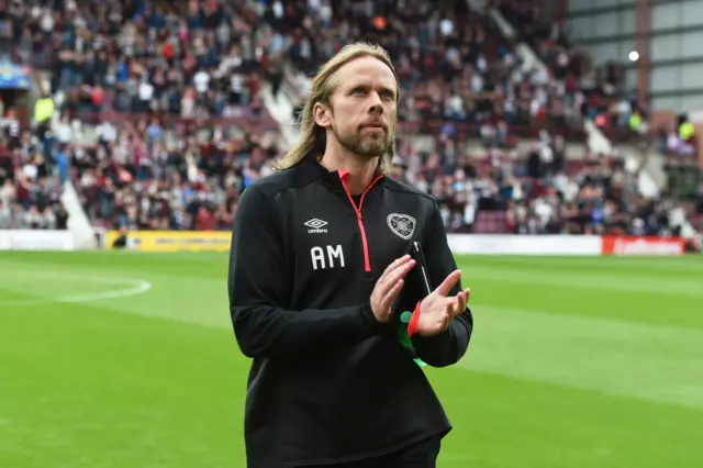 Hearts assistant Austin MacPhee applauds the Hearts fans