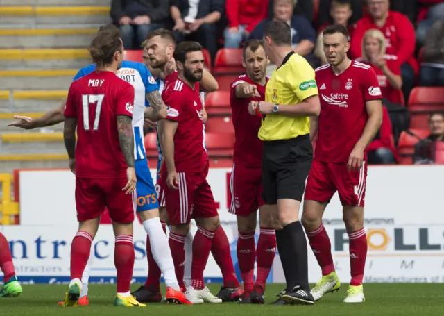 Aberdeen players plead the case for Mikey Devlin