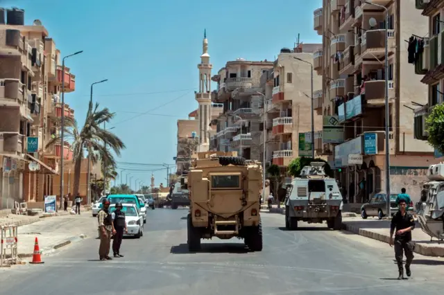 A picture taken on July 26, 2018 shows Egyptian policemen driving on a road leading to the North Sinai provincial capital of El-Arish.