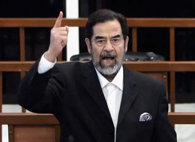 Former Iraqi President Saddam Hussein shouts as he receives his guilty verdict during his trial in the fortified 'green zone', on November 5, 2006 in Baghdad, Iraq