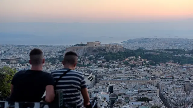 Two men look out over Athens