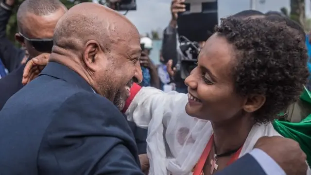 Ethiopian leader of the former armed movement Ginbot 7 Berhanu Nega (L) is greeted by a supporter upon his arrival at a meeting, in Addis Ababa, to celebrate his return after 11 years in exile, on September 9, 2018.