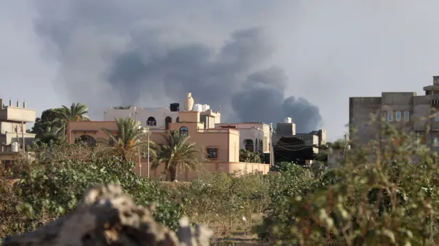 Smoke rises during heavy clashes between rival factions in Tripoli