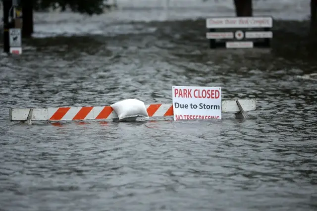 Flooded park with sign saying PARK CLOSED DUE TO STORM