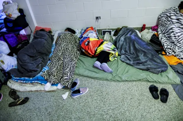 People are seen inside a shelter run by Red Cross before Hurricane Florence comes ashore in Grantsboro, North Carolina