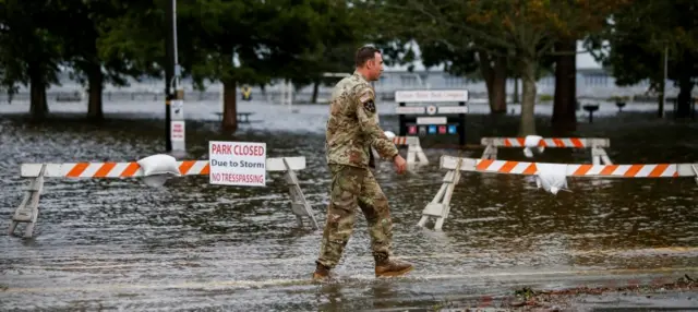 n Army member walks near the flooded Union Point Park Complex as the Hurricane Florence comes ashore in New Bern, North Carolina.