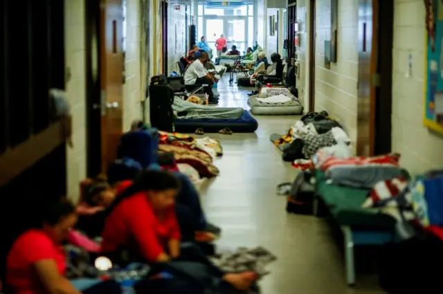 People are seen inside a shelter run by Red Cross before Hurricane Florence comes ashore in Grantsboro, North Carolina